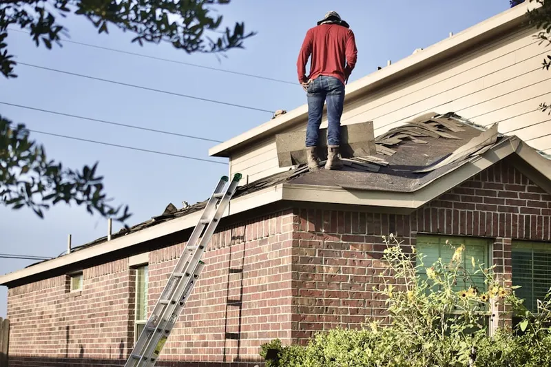 Professional roofer working on a residential roof in Villa Monticello